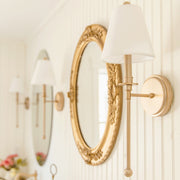 Riverdale 1 Light 6" Sconce in Aged Brass in a room setting