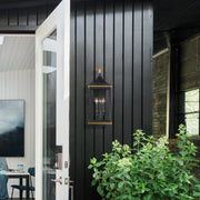 Simpson 3 Light 10" Outdoor Sconce in Matte Black + Textured Gold in a room setting