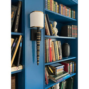 Sloane 1 Light 5" Sconce in Vibrant Gold + Black Forged in a room setting