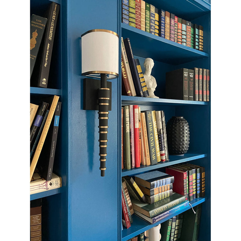 Sloane 1 Light 5" Sconce in Vibrant Gold + Black Forged in a room setting