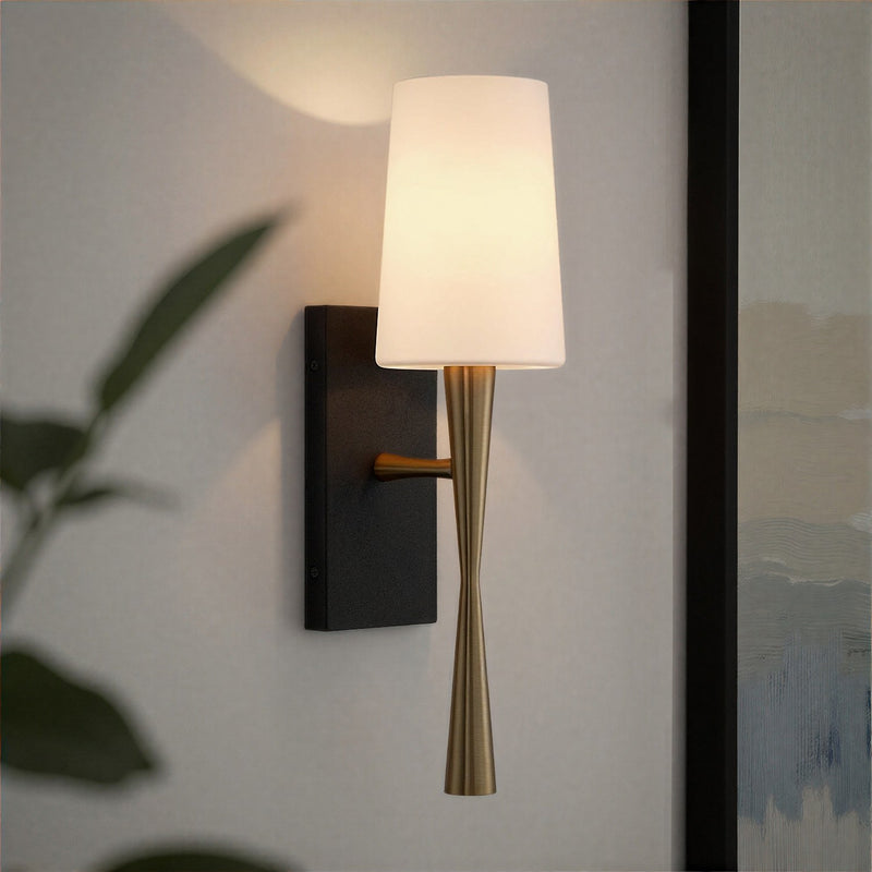 Trenton 1 Light 5" Sconce in Aged Brass + Black Forged in a room setting