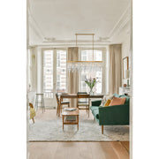 Winfield 6 Light 49" Linear Pendant in Antique Gold in a room setting