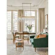 Winfield 6 Light 49" Linear Pendant in Antique Gold in a room setting