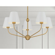 Xavier 5 Light 28" Chandelier in Vibrant Gold in a room setting