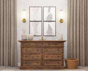 Solange 1 Light 4.75" Wall Sconce in Modern Gold in a room setting