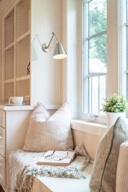 Regent 1 Light Wall Sconce in Brushed Nickel in a room setting