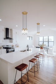 Arden 5 Light 12" Pendant in Rubbed Brass in a room setting