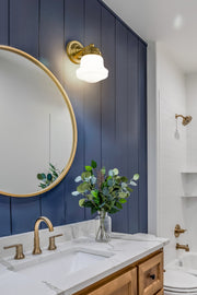 Vaughn 1 Light 6" Wall Sconce in Luxe Gold in a room setting