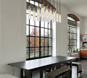 Beau 17 Light 42" Linear Pendant in Rubbed Brass in a room setting