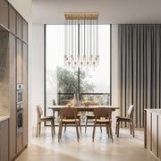 Beau 17 Light 42" Linear Pendant in Rubbed Brass in a room setting